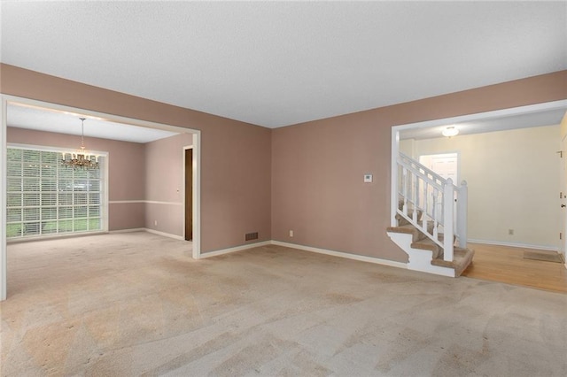 13220 W 76th St, Lenexa, KS 66216 - carpeted spare room with a chandelier and stairs