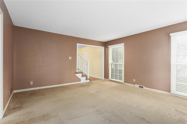 13220 W 76th St, Lenexa, KS 66216 - empty room featuring stairway and light colored carpet