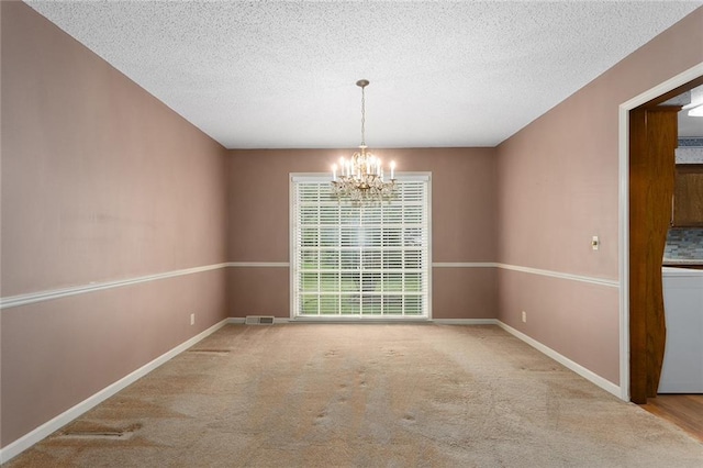 13220 W 76th St, Lenexa, KS 66216 - carpeted empty room with a chandelier, a textured ceiling, and washer / dryer