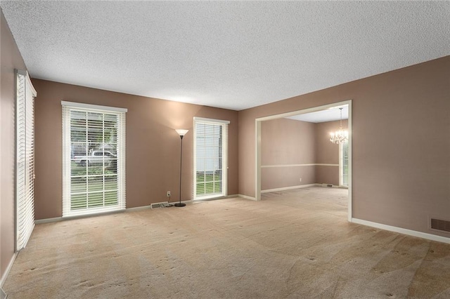 13220 W 76th St, Lenexa, KS 66216 - carpeted empty room with a chandelier and a textured ceiling