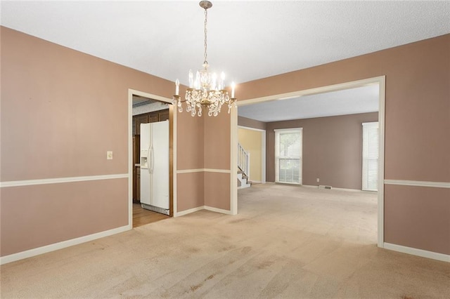 13220 W 76th St, Lenexa, KS 66216 - empty room featuring light colored carpet, stairway, and a chandelier