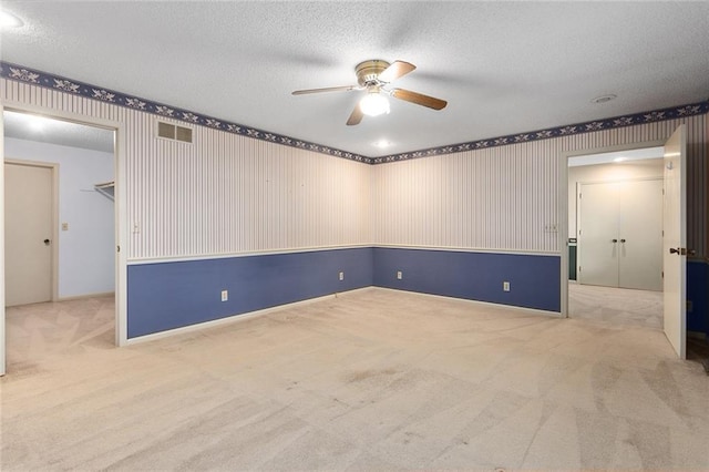 13220 W 76th St, Lenexa, KS 66216 - carpeted spare room featuring a ceiling fan, a textured ceiling, and wallpapered walls