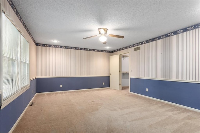 13220 W 76th St, Lenexa, KS 66216 - carpeted empty room featuring ceiling fan, a textured ceiling, and wallpapered walls