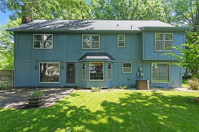 13220 W 76th St, Lenexa, KS 66216 - view of front of property with board and batten siding, a chimney, and a front yard