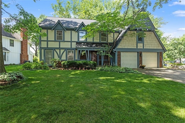 13220 W 76th St, Lenexa, KS 66216 - tudor-style house with brick siding, a garage, a front yard, and concrete driveway