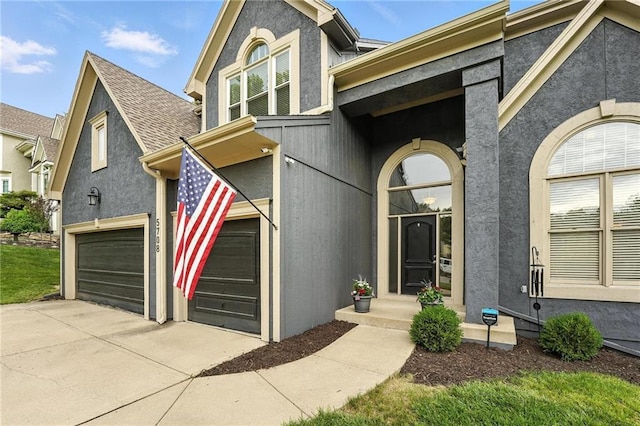 5708 Cottonwood St, Shawnee, KS 66216 - view of front of home with stucco siding, concrete driveway, and a garage