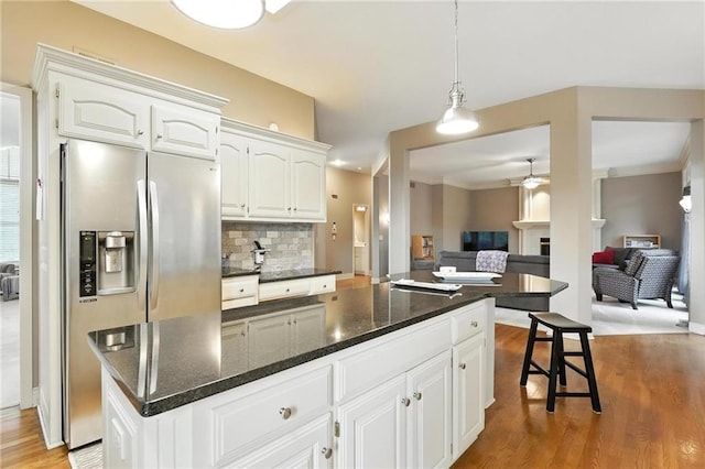 5708 Cottonwood St, Shawnee, KS 66216 - kitchen with stainless steel fridge with ice dispenser, ceiling fan, light wood-type flooring, white cabinets, and backsplash