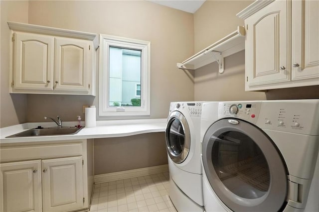 5708 Cottonwood St, Shawnee, KS 66216 - washroom with cabinet space, washer and dryer, and light tile patterned floors