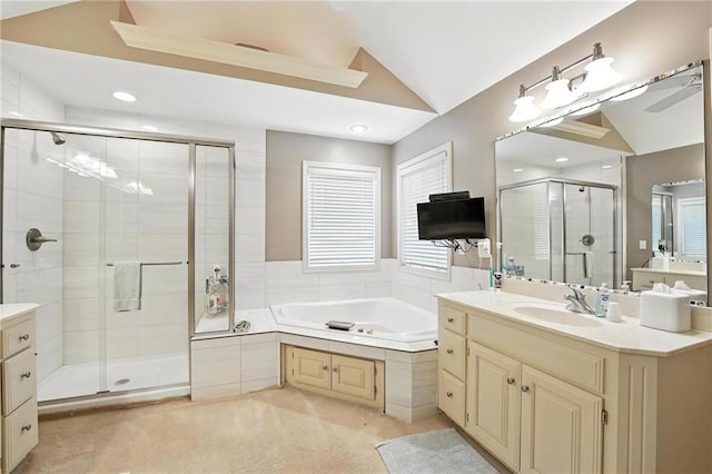 5708 Cottonwood St, Shawnee, KS 66216 - full bathroom with vaulted ceiling, a shower stall, vanity, a garden tub, and recessed lighting