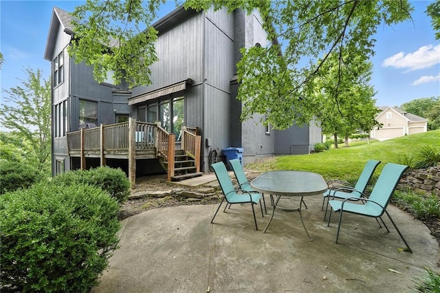 5708 Cottonwood St, Shawnee, KS 66216 - back of property with a patio, a wooden deck, and a lawn