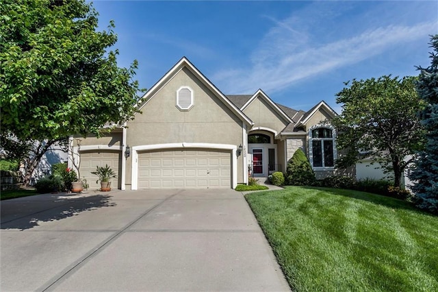 19326 W 98th St, Lenexa, KS 66220 - view of front of property featuring concrete driveway, an attached garage, a front yard, and stucco siding