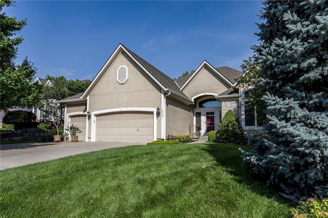 19326 W 98th St, Lenexa, KS 66220 - view of front of home with an attached garage, stucco siding, a front yard, and concrete driveway