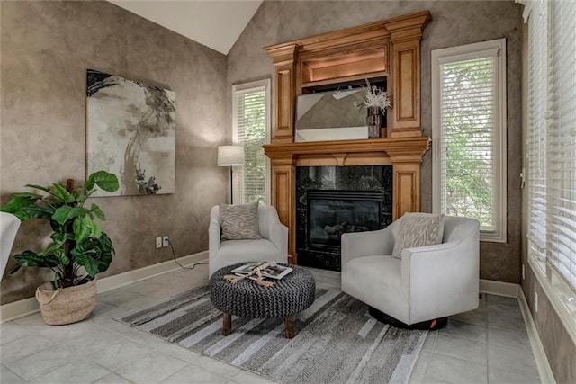 19326 W 98th St, Lenexa, KS 66220 - living area with lofted ceiling, plenty of natural light, a premium fireplace, and light tile patterned flooring