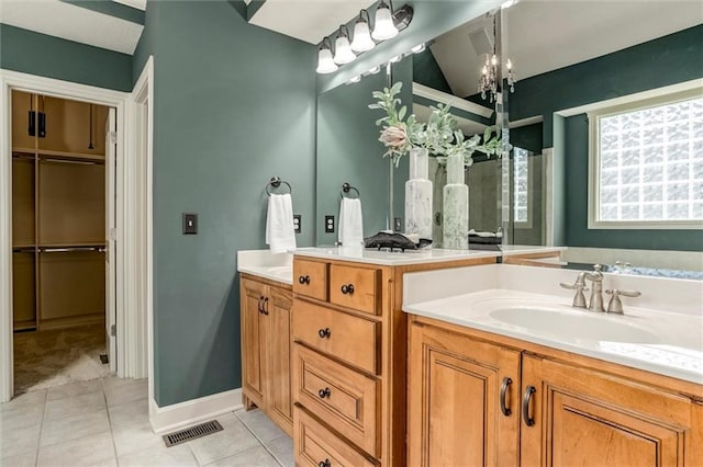19326 W 98th St, Lenexa, KS 66220 - full bathroom featuring two vanities, tile patterned floors, and a chandelier