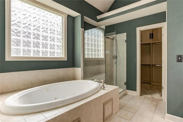 19326 W 98th St, Lenexa, KS 66220 - bathroom featuring a shower stall, a tub with jets, tile patterned floors, lofted ceiling, and a spacious closet