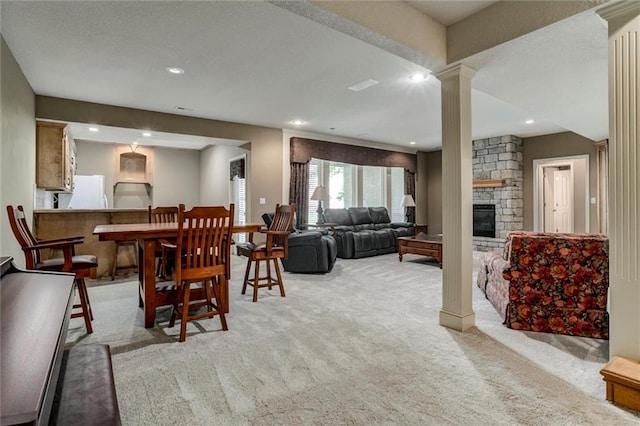 19326 W 98th St, Lenexa, KS 66220 - dining space with decorative columns, light carpet, a stone fireplace, and recessed lighting