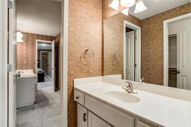19326 W 98th St, Lenexa, KS 66220 - bathroom featuring vanity, a textured ceiling, and wallpapered walls