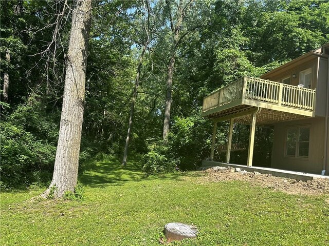 1411 NE 85th Ter, Kansas City, MO 64155 - view of grassy yard featuring a wooden deck and a wooded view