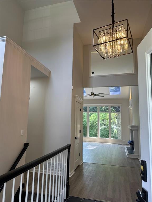 1411 NE 85th Ter, Kansas City, MO 64155 - corridor featuring a towering ceiling, wood finished floors, an upstairs landing, and a chandelier