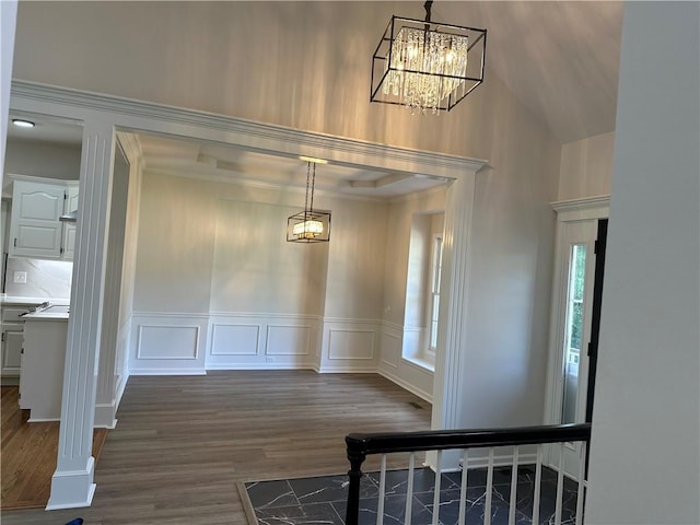 1411 NE 85th Ter, Kansas City, MO 64155 - unfurnished dining area with a chandelier, dark wood-style flooring, a decorative wall, a high ceiling, and wainscoting