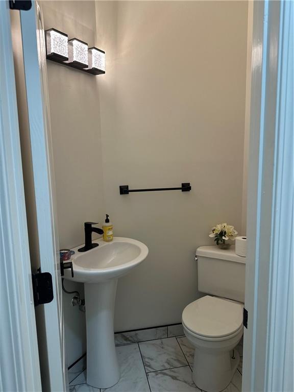 1411 NE 85th Ter, Kansas City, MO 64155 - bathroom with marble finish floors and toilet