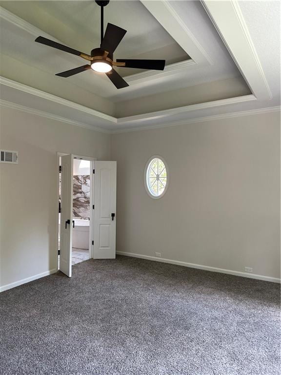 1411 NE 85th Ter, Kansas City, MO 64155 - empty room with a tray ceiling, healthy amount of natural light, a ceiling fan, dark colored carpet, and crown molding