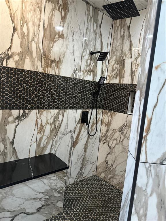 1411 NE 85th Ter, Kansas City, MO 64155 - detailed view of a marble finish shower