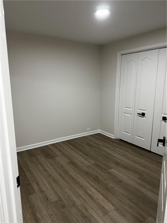 1411 NE 85th Ter, Kansas City, MO 64155 - unfurnished bedroom with dark wood-style floors and a closet