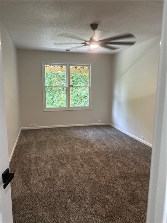 1411 NE 85th Ter, Kansas City, MO 64155 - unfurnished room featuring a ceiling fan, dark colored carpet, and a textured ceiling