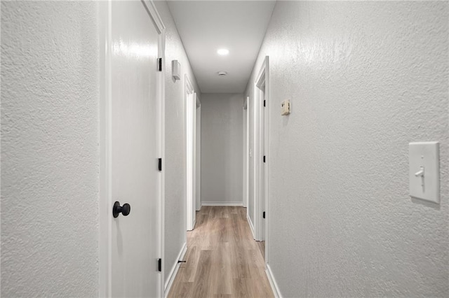 508 N Lincoln St, Olathe, KS 66061 - corridor with a textured wall, light wood-style flooring, and recessed lighting