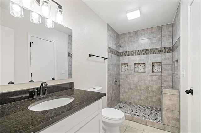 508 N Lincoln St, Olathe, KS 66061 - bathroom featuring vanity, a tile shower, and tile patterned flooring
