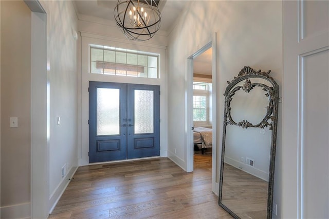 12605 W 169th St, Overland Park, KS 66221 - entryway featuring light wood finished floors, a chandelier, and french doors