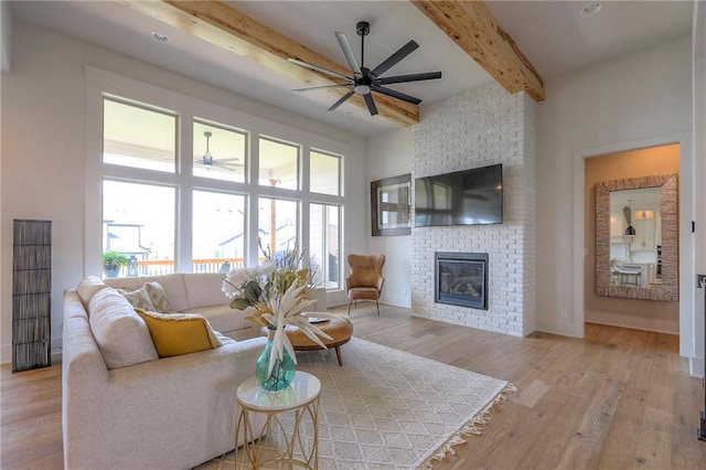12605 W 169th St, Overland Park, KS 66221 - living area featuring a ceiling fan, beam ceiling, light wood-style flooring, and a fireplace