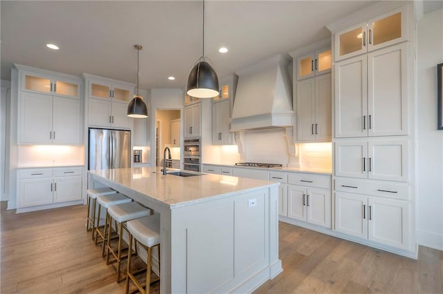 12605 W 169th St, Overland Park, KS 66221 - kitchen featuring premium range hood, stainless steel appliances, light wood-style floors, decorative backsplash, and recessed lighting