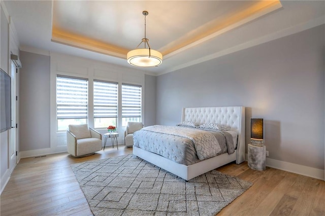 12605 W 169th St, Overland Park, KS 66221 - bedroom featuring a tray ceiling and light wood-style floors