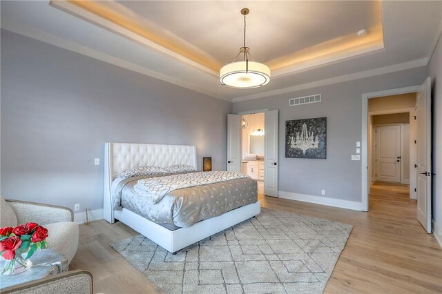 12605 W 169th St, Overland Park, KS 66221 - bedroom with a raised ceiling, wood finished floors, crown molding, and ensuite bath