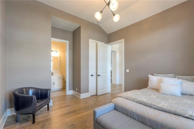 12605 W 169th St, Overland Park, KS 66221 - bedroom featuring light wood-style floors, lofted ceiling, a chandelier, and ensuite bath