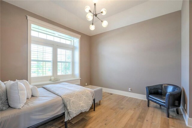 12605 W 169th St, Overland Park, KS 66221 - bedroom with light wood-style flooring, multiple windows, and a chandelier