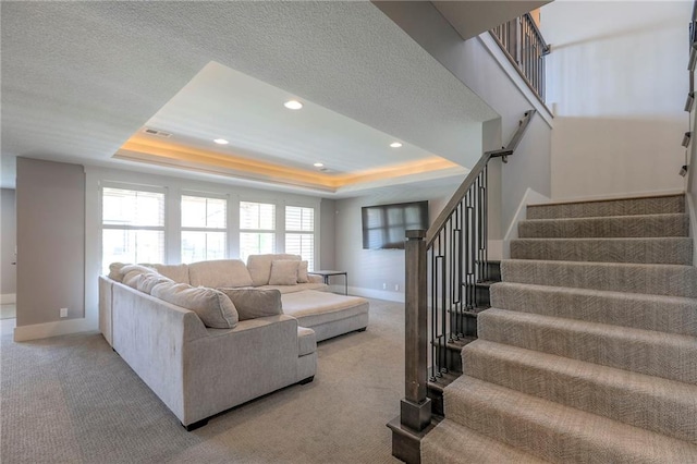 12605 W 169th St, Overland Park, KS 66221 - living area featuring a raised ceiling, stairway, healthy amount of natural light, recessed lighting, and a textured ceiling