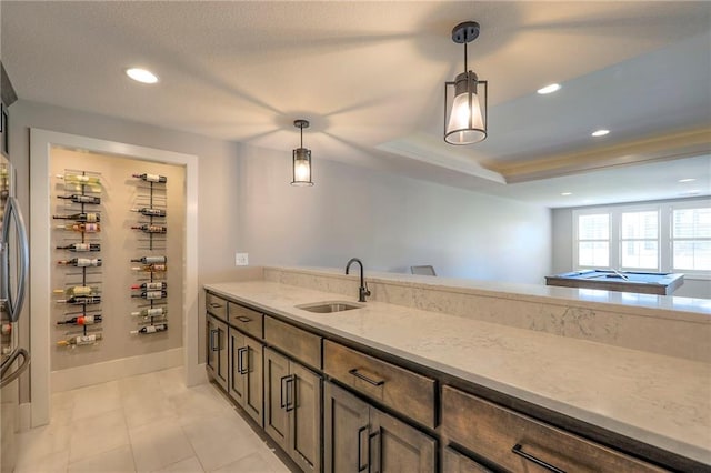 12605 W 169th St, Overland Park, KS 66221 - kitchen with light stone counters, decorative light fixtures, a tray ceiling, light tile patterned flooring, and recessed lighting