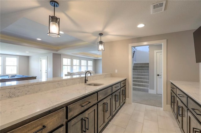 12605 W 169th St, Overland Park, KS 66221 - kitchen featuring light stone countertops, hanging light fixtures, recessed lighting, and dark brown cabinetry