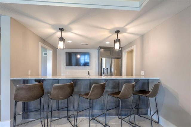 12605 W 169th St, Overland Park, KS 66221 - bar area featuring stainless steel fridge with ice dispenser, pendant lighting, and recessed lighting
