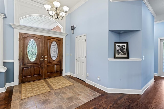 31134 W 161st St, Excelsior Springs, MO 64024 - foyer featuring ornamental molding, a chandelier, a towering ceiling, decorative columns, and wood finished floors