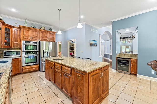31134 W 161st St, Excelsior Springs, MO 64024 - kitchen with appliances with stainless steel finishes, wine cooler, light tile patterned floors, crown molding, and an island with sink