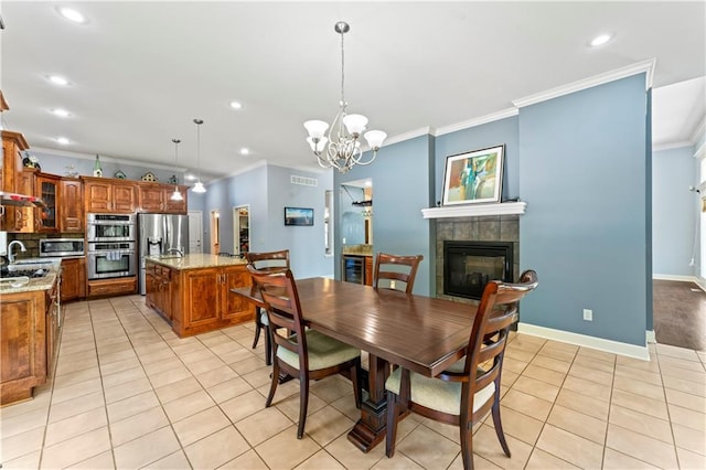 31134 W 161st St, Excelsior Springs, MO 64024 - dining area featuring crown molding, light tile patterned floors, a fireplace, a chandelier, and recessed lighting