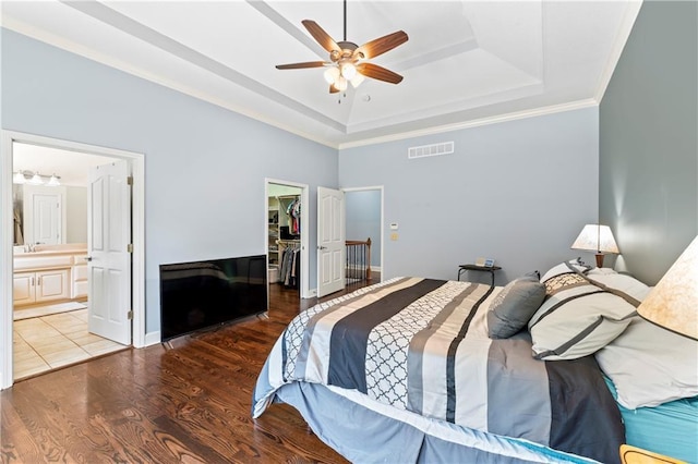 31134 W 161st St, Excelsior Springs, MO 64024 - bedroom featuring a raised ceiling, a walk in closet, wood finished floors, a closet, and ensuite bathroom