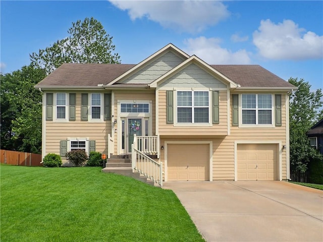 4301 NE 84th Ter, Kansas City, MO 64156 - raised ranch featuring an attached garage and concrete driveway