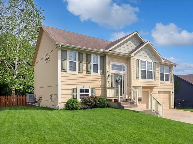 4301 NE 84th Ter, Kansas City, MO 64156 - split foyer home featuring concrete driveway and an attached garage