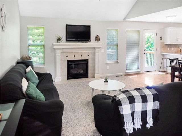 4301 NE 84th Ter, Kansas City, MO 64156 - living room featuring lofted ceiling, healthy amount of natural light, and a fireplace