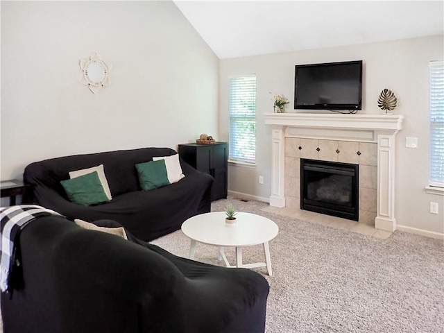 4301 NE 84th Ter, Kansas City, MO 64156 - carpeted living room featuring lofted ceiling and a fireplace